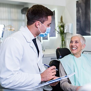 Woman smiling at dentist during checkup