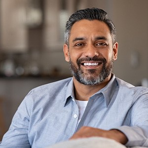 Mature man smiling in blue shirt