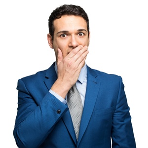 embarrassed man covering mouth