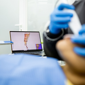 Dentist taking digital impressions of a patient's teeth