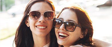 two girls smiling with sunglasses on