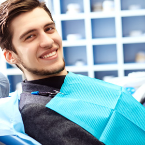 Smiling young man leaning back in the dental chair
