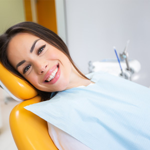 Woman smiling while sitting in treatment chair